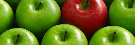 Red apple in basket of green apples
